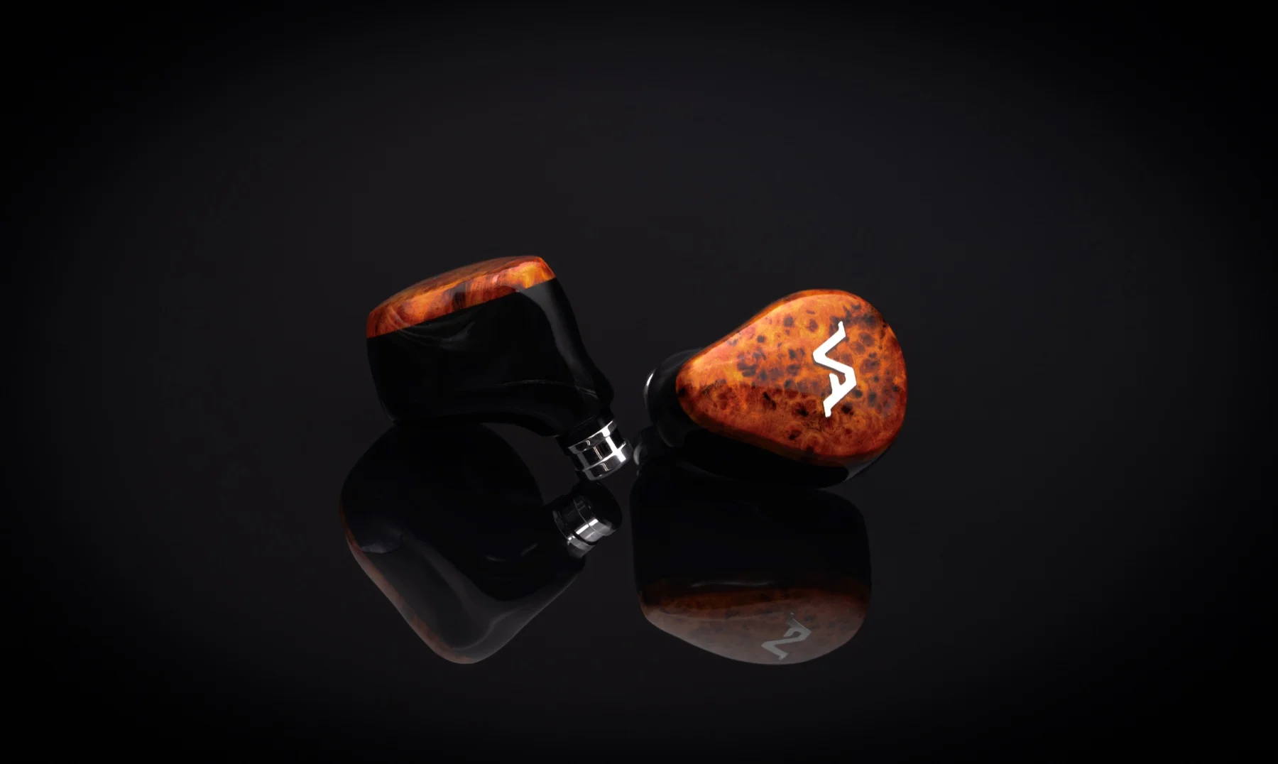 Amber burl faceplates on a pair of black shells, mirrored on a gloss black surface