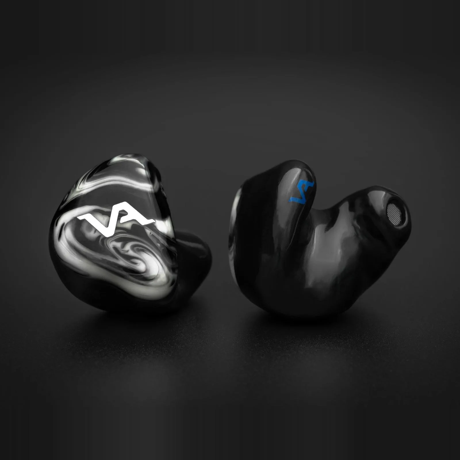 Virtus Audio Vortex — custom-molded pair, monochrome swirl faceplate beside the hand-built shell and its moulded canal