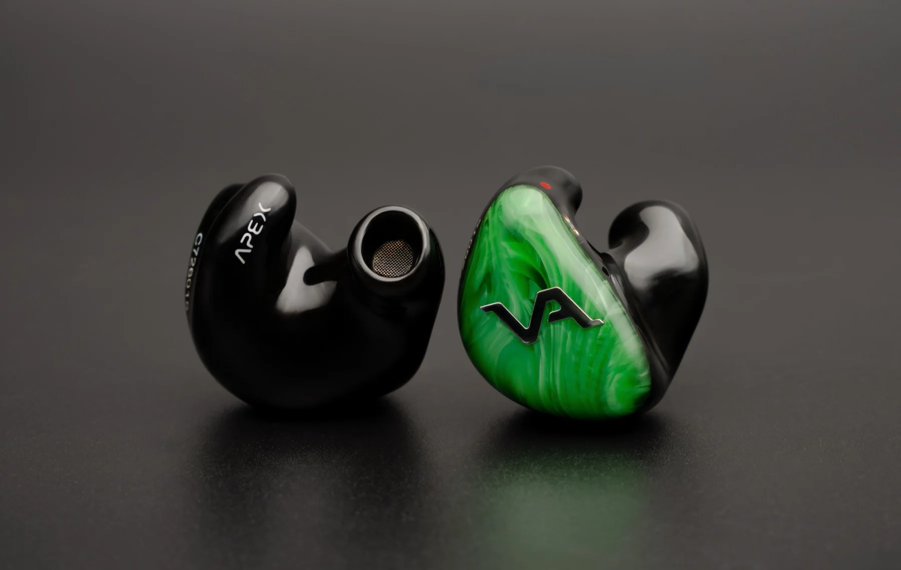 Virtus Audio Apex — jade marbled faceplate beside the polished black shell, turned to show its nozzle