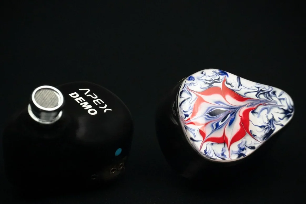 Virtus Audio Apex demo pair — red, white and blue marbled faceplate beside the shell it mounts on